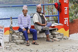 Two old Nepalese sitting on a bench at Lake Phewa