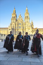 Atuna of young men in traditional University dress who play and sing traditional Galician songs in front of the Cathedral of Santiago de Compostela