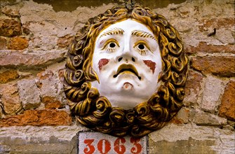 Mask on house wall