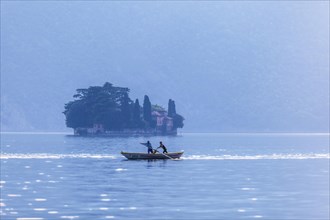 Two men rowing a Naet the traditional boat of the region near Monte Isola