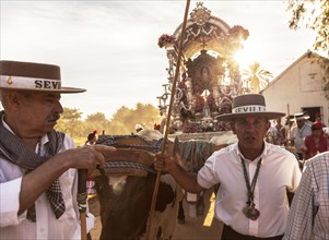 Men in traditional attire from the Seville Hermandad with the Simpecado during the annual Romeria of El Rocio