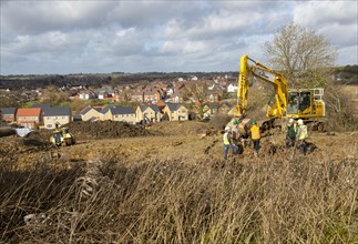 Workers and machinery doing groundwork new housing development