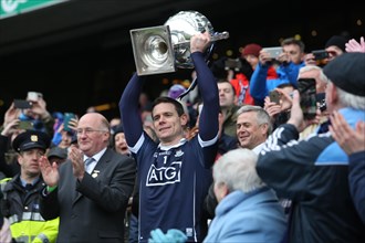 Gaelic footballer and Dublin captain Stephen Cluxton raises the League trophy in Croke Park