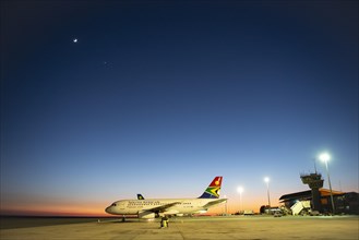 South African Airline on tarmac at sunrise