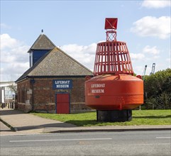 Red navigation buoy Lifeboat Museum building
