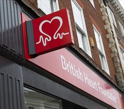Wall mounted sign outside British Heart Foundation charity shop