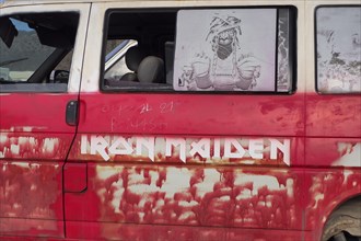 Side view of red van of an Iron Maiden fan
