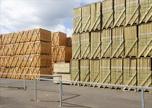 Stacks of wooden fence panels piled up awaiting distribution