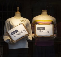 Positive messages during Covid coronavirus lockdown held by mannequins in shop window