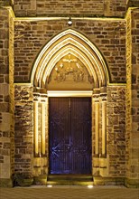 Illuminated entrance to the parish church of St. Suitbertus