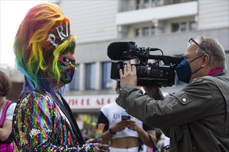 Colourful outfit and first interview at start of 2021 Christopher Street Parade. Berlin