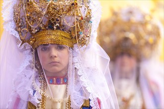 Portrait of a girl in the unique traditional attire of the Veroniche during the historic processions of Holy Thursday in Marsala