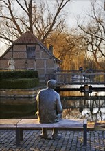 Bronze sculpture of the local poet Paul Advena at the water mill in Heek-Nienborg