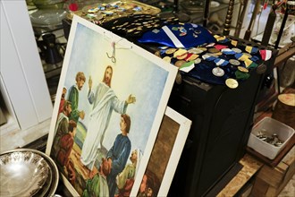 Image of Jesus and various orders for sale at a flea market