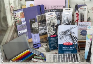 Display of various art materials for drawing sketching in shop window