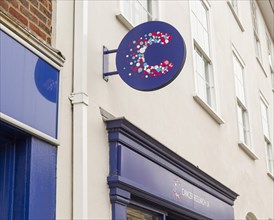 Cancer Research charity shop signs outside High Street store
