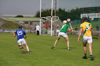 GAA player with hurley and ball during a game as Lixnaw win Kerry county hurling county final