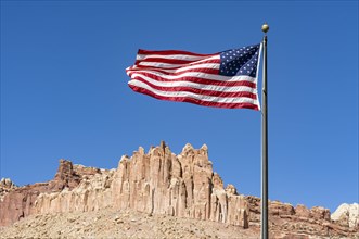 US flag fluttering against a blue sky