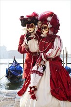Couple in beautiful costumes on the bacino di San Marco during Venetian Carnival