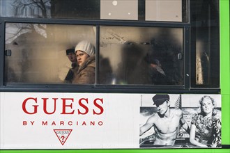 Two young woman looking out of a bus window in freezing temperatures during Siberian Winter in Irkutsk