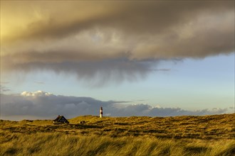 Dune landscape with storm clouds and List-ost lighthouse