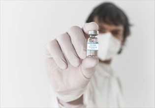 Doctor holding a vaccine bottle and syringe