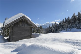 Winter landscape with wooden cabin