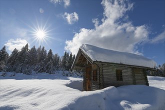 Winter landscape with wooden cabin