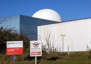 Signs boundary and no drone zone with white dome of Sizewell B power station