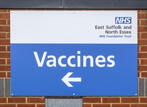 Sign with direction arrow 'Vaccines'