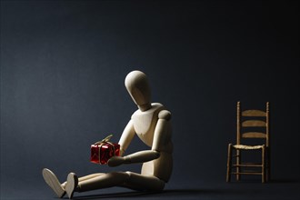 A mannequin is sitting with a gift