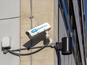 CCTV surveillance camera operated by ACE Security mounted on wall of building