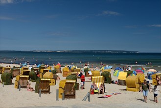 Beach chairs with holidaymakers on the beach and Baltic Sea