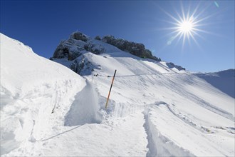 Path on Karwendelgrube Karwendel mountainrange with sun in winter