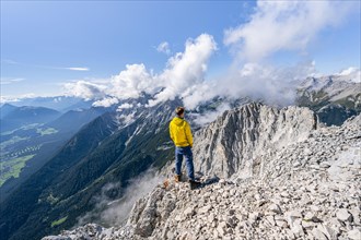 Hiker on the west summit of Hohe Munde