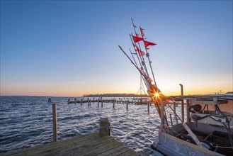 Fishing cutter in the harbour at the Salzhaff at sunset