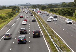 Traffic vehicles driving M4 motorway view west from near Dauntsey