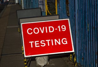Close up of red street sign for COVID-19 Testing