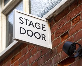 Stage Door sign fixed on brick wall