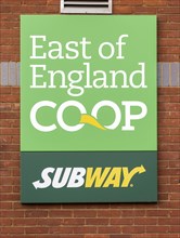 East of England Co-Op and Subway sign on brick wall