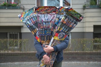 Man with many New Year's Eve rockets