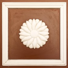 Wooden rosette as decoration on a front door