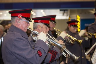 Brass band musicians play their trumpets at a fundraiser. London