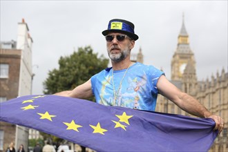Anti-Brexit protest at parliament by man with EU flag in favor of remaining in the EU