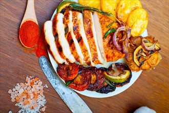 Roasted grilled BBQ chicken breast with herbs and spices rustic style