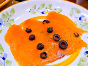Norwegian smoked salmon with black olives on top
