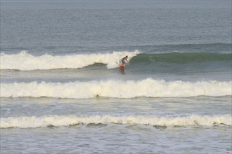 Surfer riding the wave at Praia de Mocambique