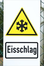 Sign warning of icefall on a radio mast