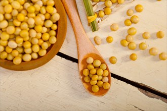 Organic soya beans over rustic wood table macro closeup