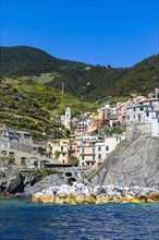 The village of Manarola with its nested pastel-coloured houses built into the hillside